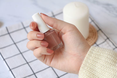 Cropped hand of woman holding pills