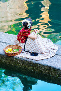 Girl holding ice cream in lake