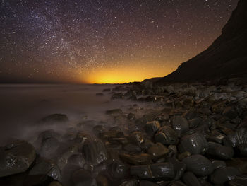 Scenic view of sea against sky at night