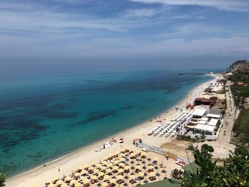 Look from above to beach, umbrellas an the sea snd sky