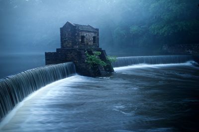 Built structure in water against building