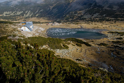 High angle view of land and sea against mountains