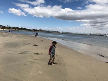 Full length of man on beach against sky