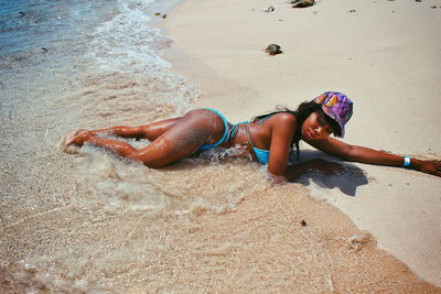 High angle view of young woman on sand at beach