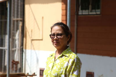 Mature woman wearing eyeglasses standing outdoors