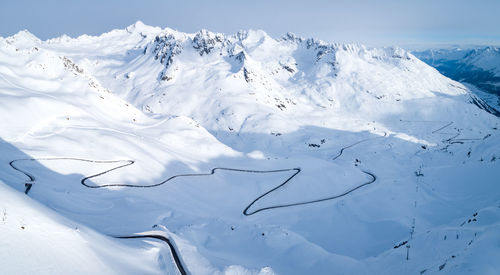 Aerial view of snowcapped mountain against sky