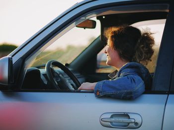 Side view of woman in car