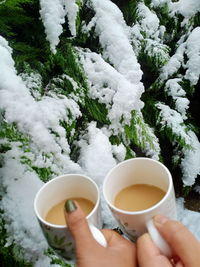 Cropped hand of woman holding coffee