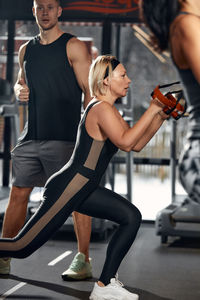 Young woman exercising in gym