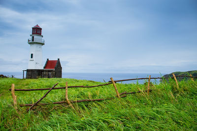 Lighthouse on grassy field