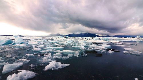 Frozen lake against sky during winter