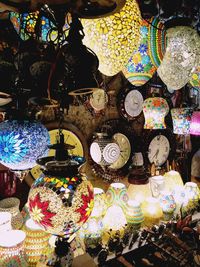 Illuminated lanterns hanging in store for sale at market stall