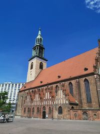 Low angle view of historic building against clear blue sky