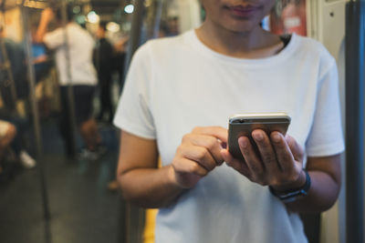 Midsection of man using mobile phone