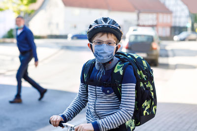 Portrait of boy wearing mask standing outdoors