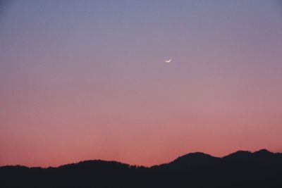 Silhouette of mountain range at dusk