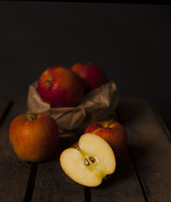 Close-up of apples on table against black background