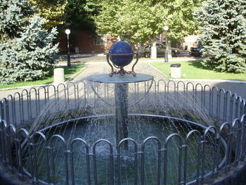 Rear view of boy sitting at park