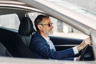 Rear view of man sitting in car