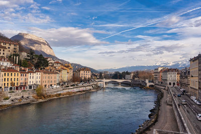 River amidst buildings in city against sky