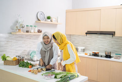Woman standing by food at home