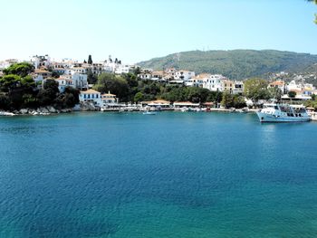 Townscape by sea against clear sky