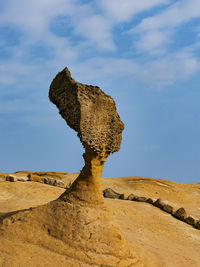 Rock formation on land against sky