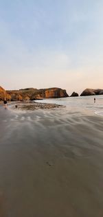 Scenic view of beach against sky during sunset