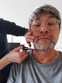 Close-up portrait of man holding camera