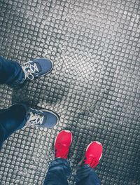 Low section of person standing on paving stone