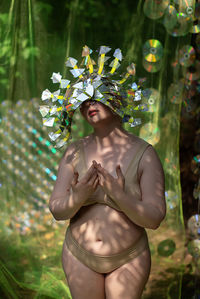 Portrait of woman in bikini and holographic mask