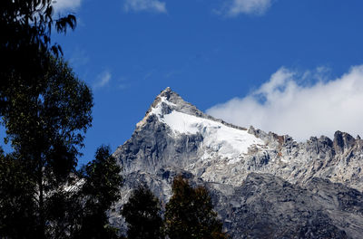 Low angle view of snowcapped mountain against sky