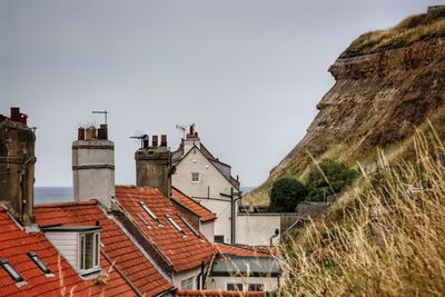 Buildings in town against sky