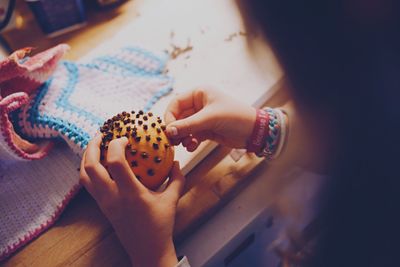 Close-up of hand holding orange