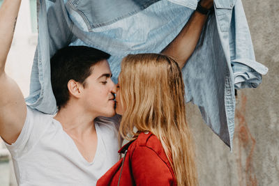 Portrait of young couple kissing