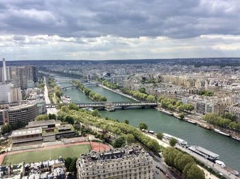 High angle view of river amidst buildings in city against sky