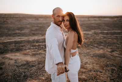 Young couple standing on land