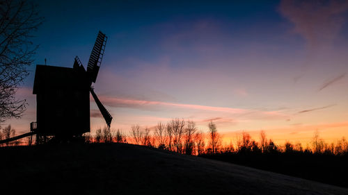 Silhouette of windmill at sunset