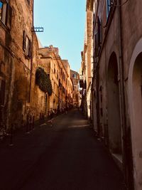 Empty alley amidst buildings in city