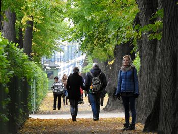 Full length portrait of woman standing against trees