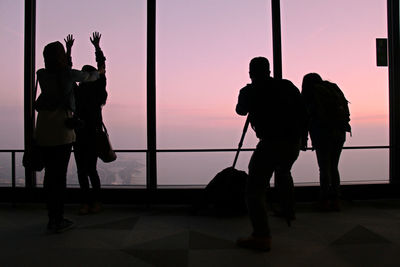 Friends in observation tower during sunrise
