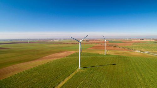 Windmill on field against sky