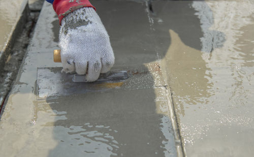 Low section of person working in puddle on street