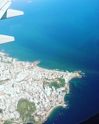 Aerial view of sea and airplane wing