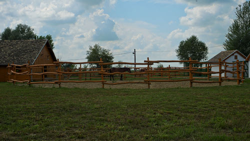 Built structure on field against sky