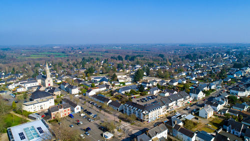 High angle view of cityscape against blue sky