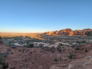 Scenic view of desert against clear blue sky