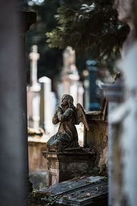 Statue against old building