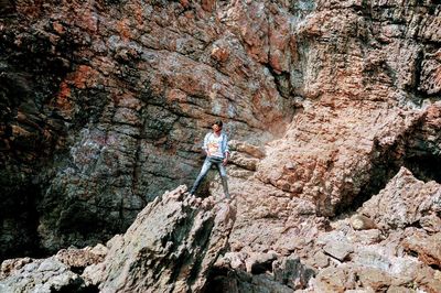 Person standing on rock with mountain in background