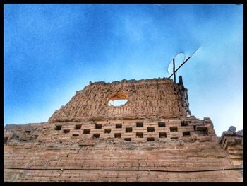 Low angle view of old ruin against blue sky